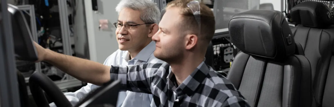Red Hat and GM Collaborate two men testing an in-vehicle operating system
