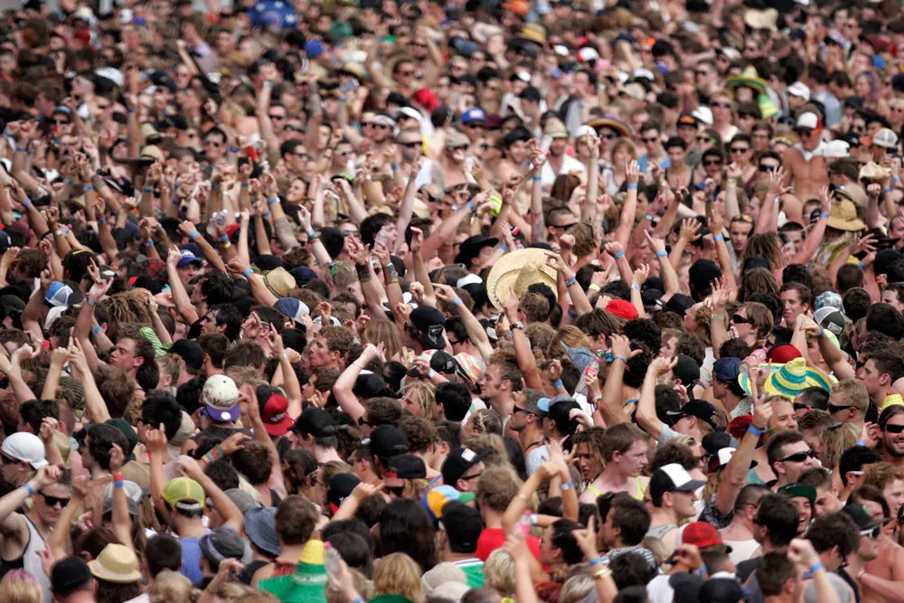A photograph of a large crowd at an event such as a concert or a football game. A photograph of a large crowd at an event such as a concert or a football game.