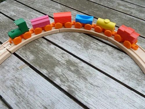 A photograph of a wooden toy train. A photograph of a wooden toy train.